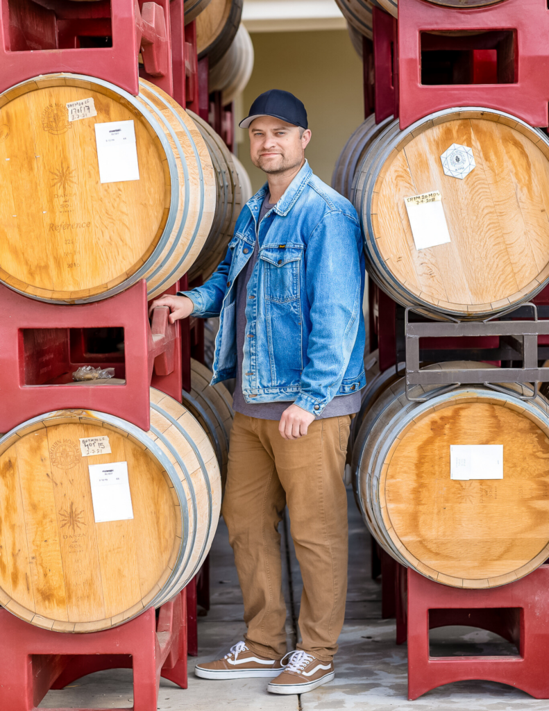 Winemaker, Justin Knight in between barrels.